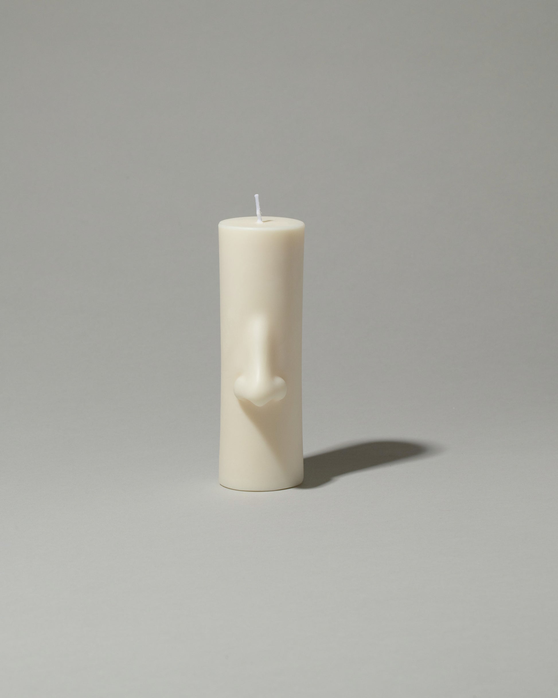 Bonam Kim Nose Pillar Candle on light color background.