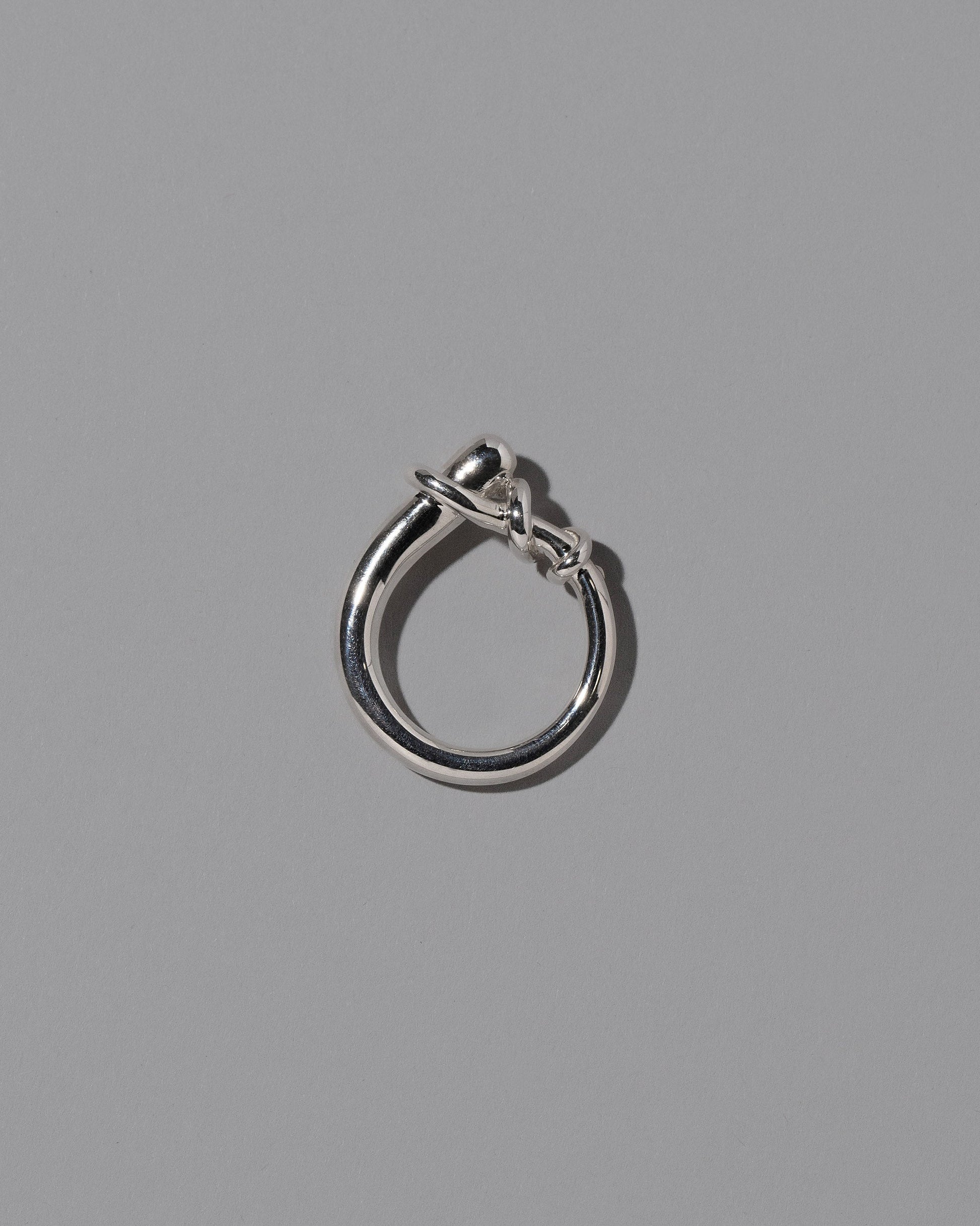 View from the side of the CRZM Sterling Silver Terrane Ring on light color background.