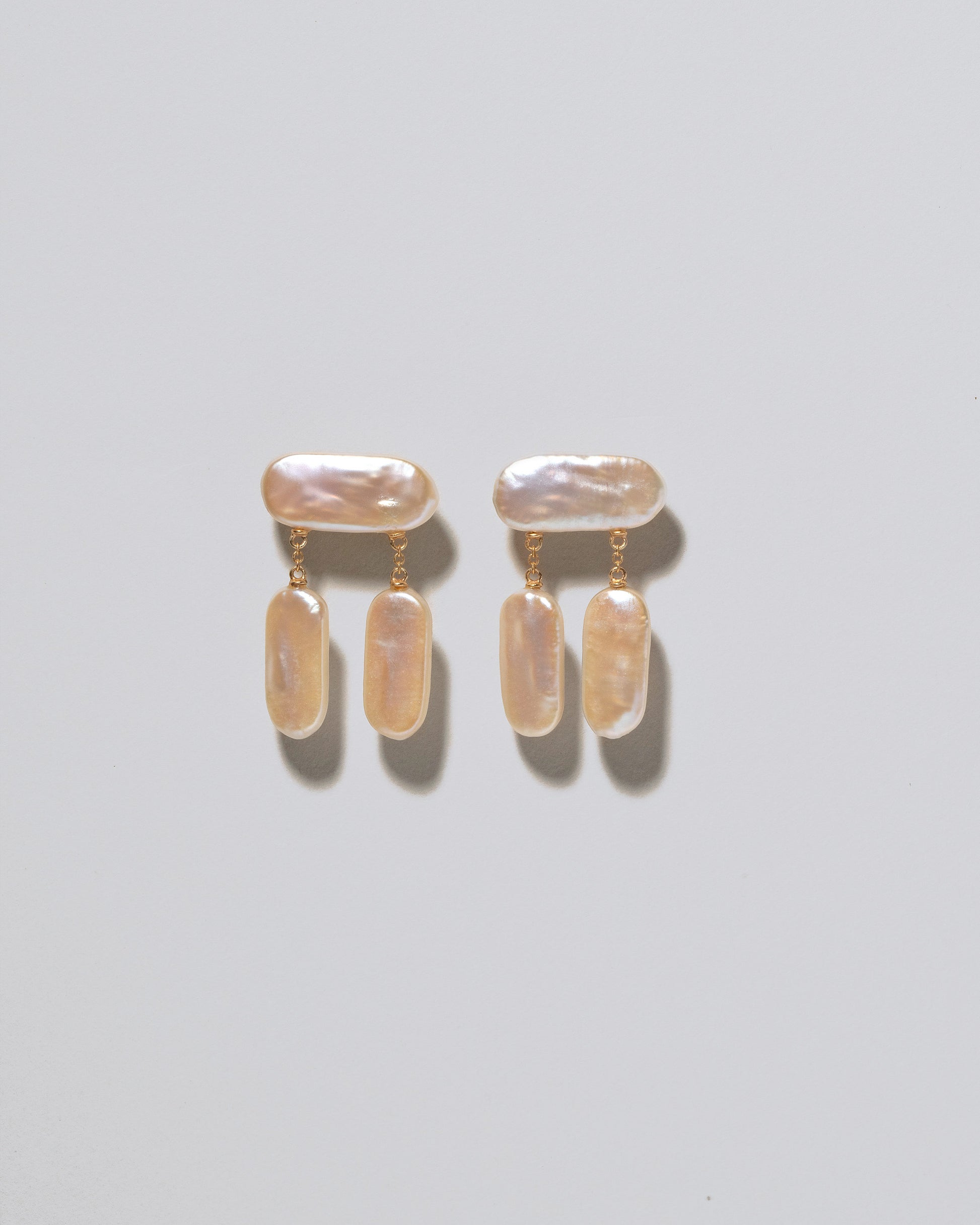 Crake Pearl Earrings on light color background.