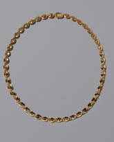 CRZM 22k Gold Mini Bedrock Necklace on light color background.