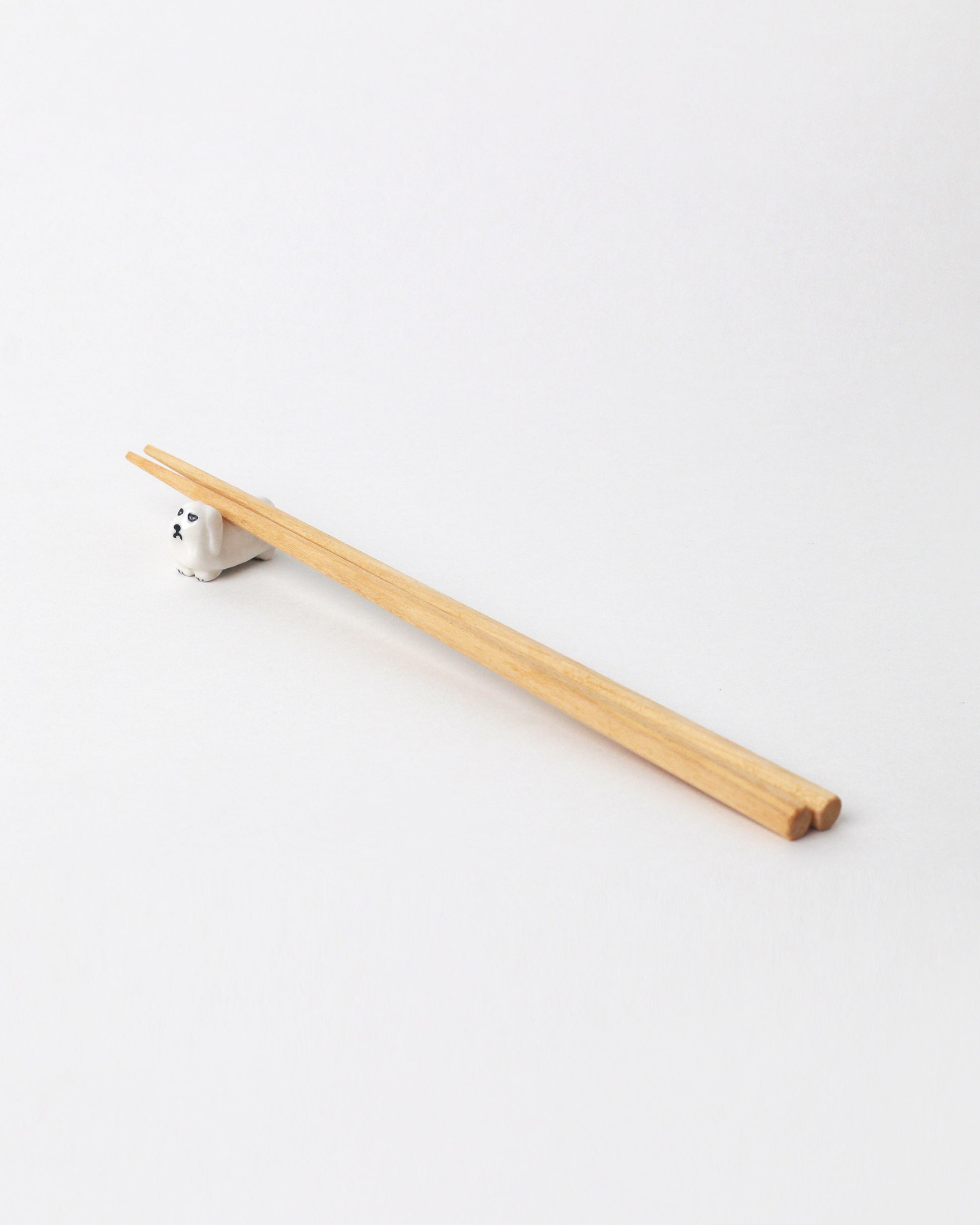 Eleonor Boström Pekingese PARK Chopstick Dog Rest on light color background. Chopsticks not included.