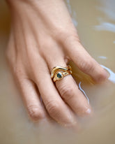 Gold Wide Planate Band and Green Sapphire Level Ring on model.