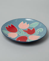 Closeup detail of the Laetitia Rouget Blue Tulip Platter on light color background.
