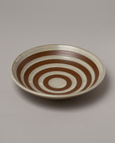 Jeremy Ayers Brown Striped Shallow Bowl on light color background.