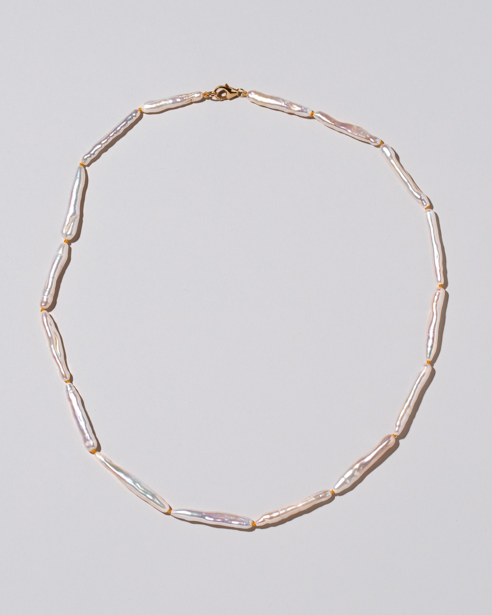 Stick Pearl Strand Necklace on light color background.