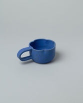 Recreation Center Blue Flower Mug on light color background.