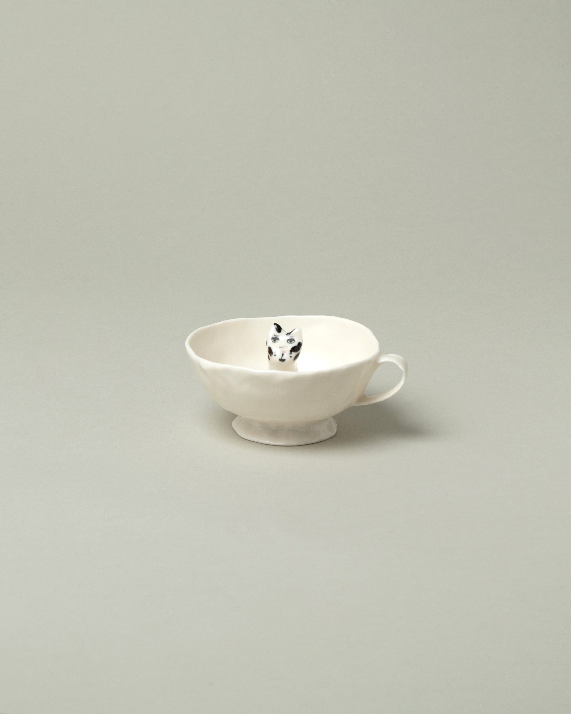Eleonor Boström Black Spots Cat Cup on light color background.
