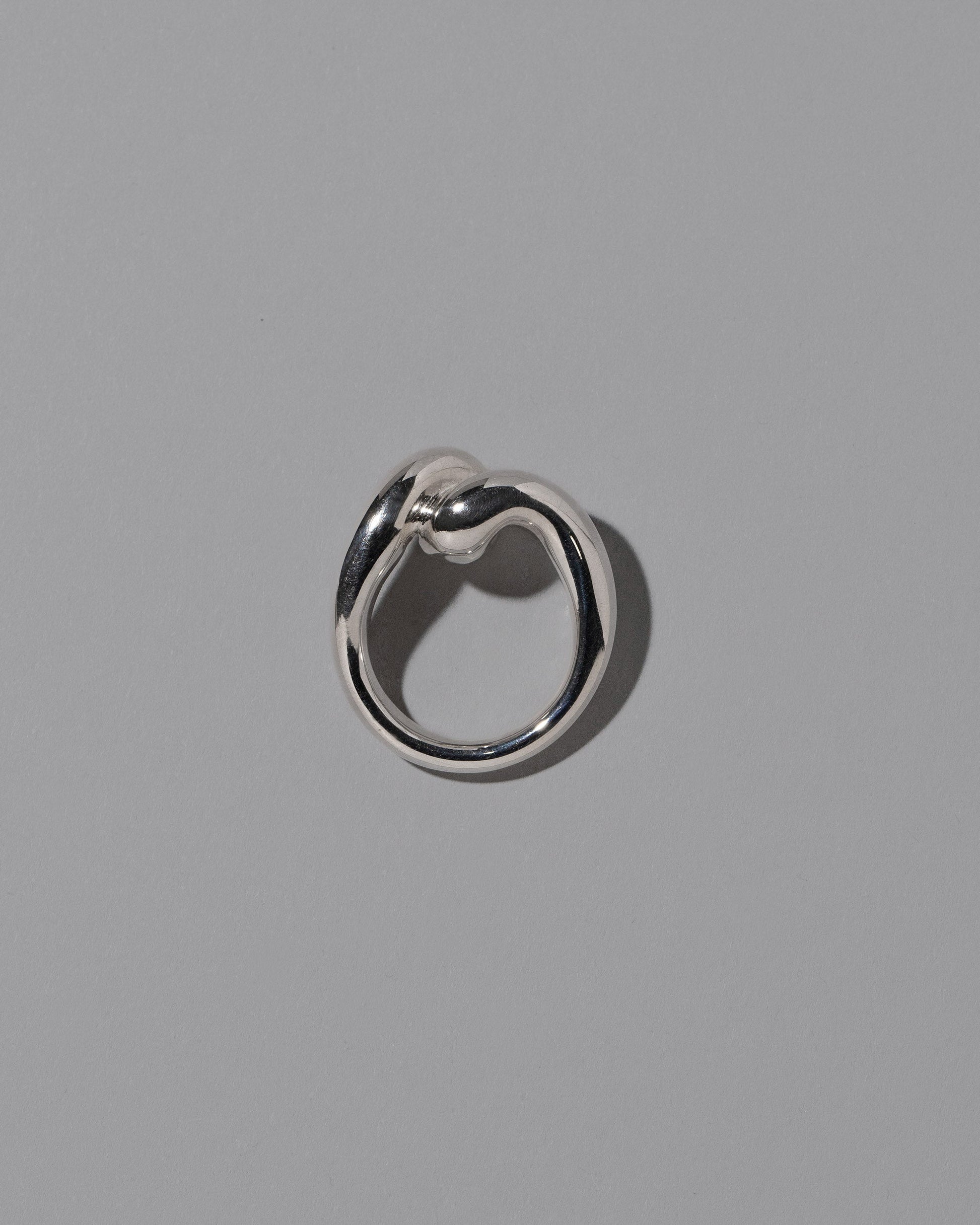 View from the side of the CRZM Sterling Silver Landform Ring on light color background.
