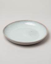 Humble Ceramics Shallow Stillness Bowl on light color background.