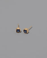 Blue Sapphire Fold Earrings on greycolor background.