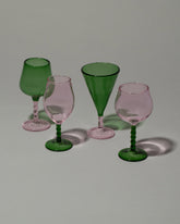 Closeup details of the Ornamental by Lameice Pink & Green Dreamlike Liquor Glass Set on light color background.