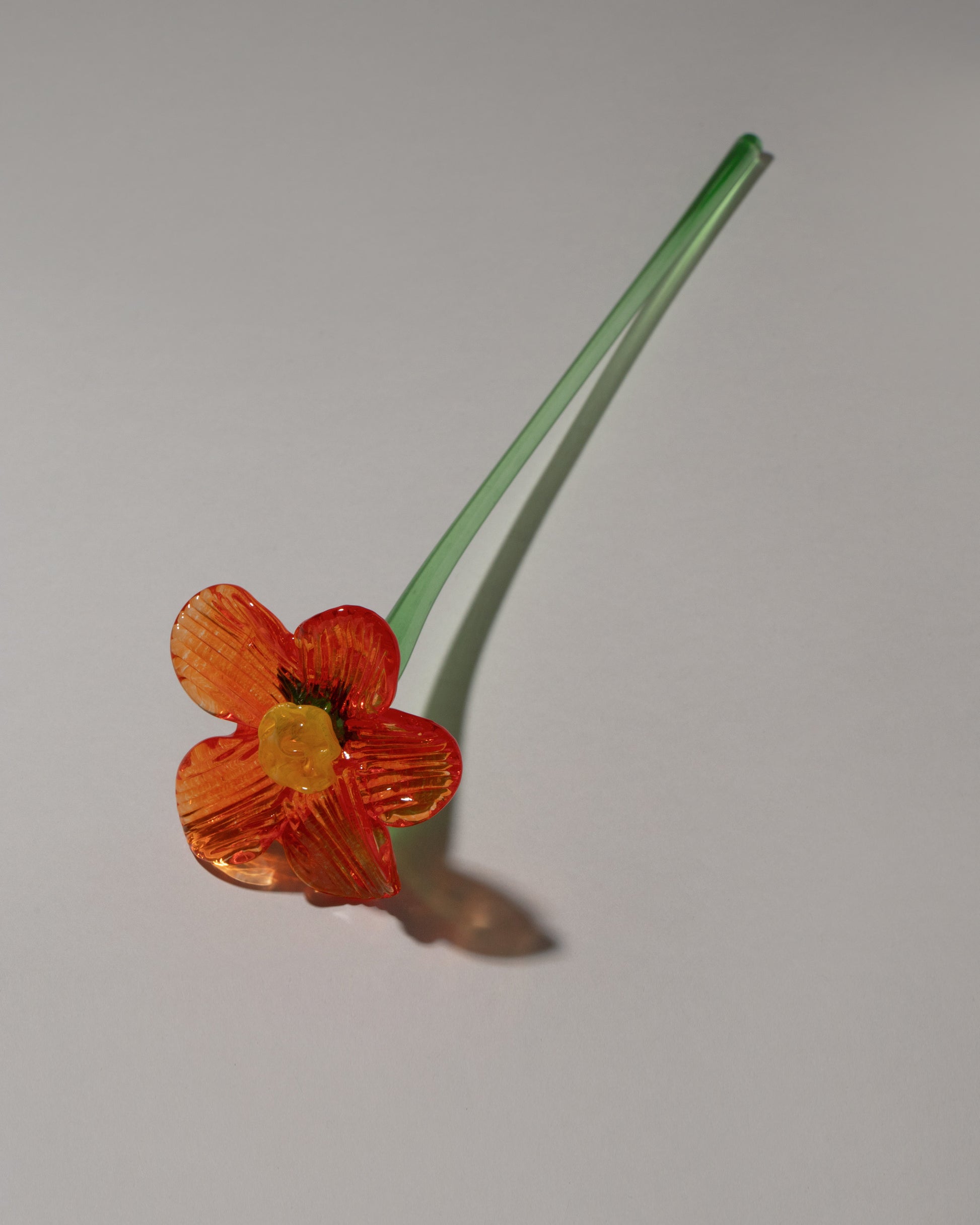 Lucie Claudia Podrabska Orange Crystal Glass Flower on light color background.