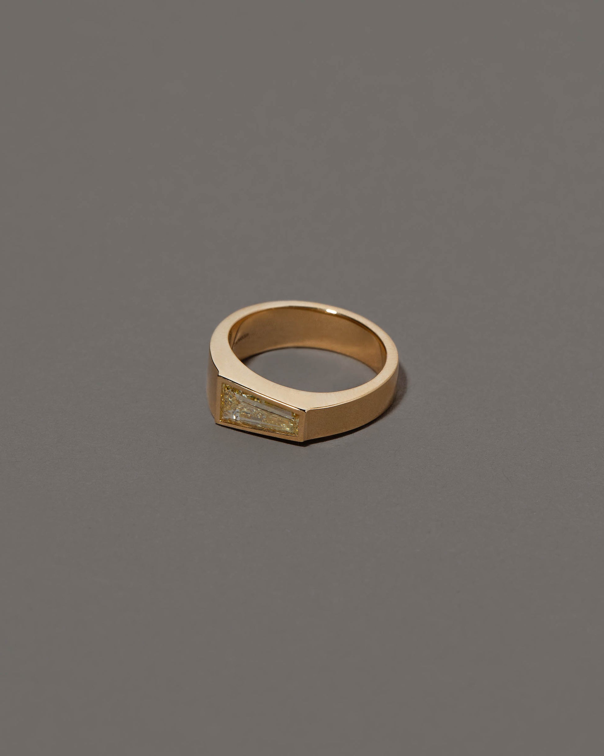 View from the side of the Joviality Ring on grey color background.