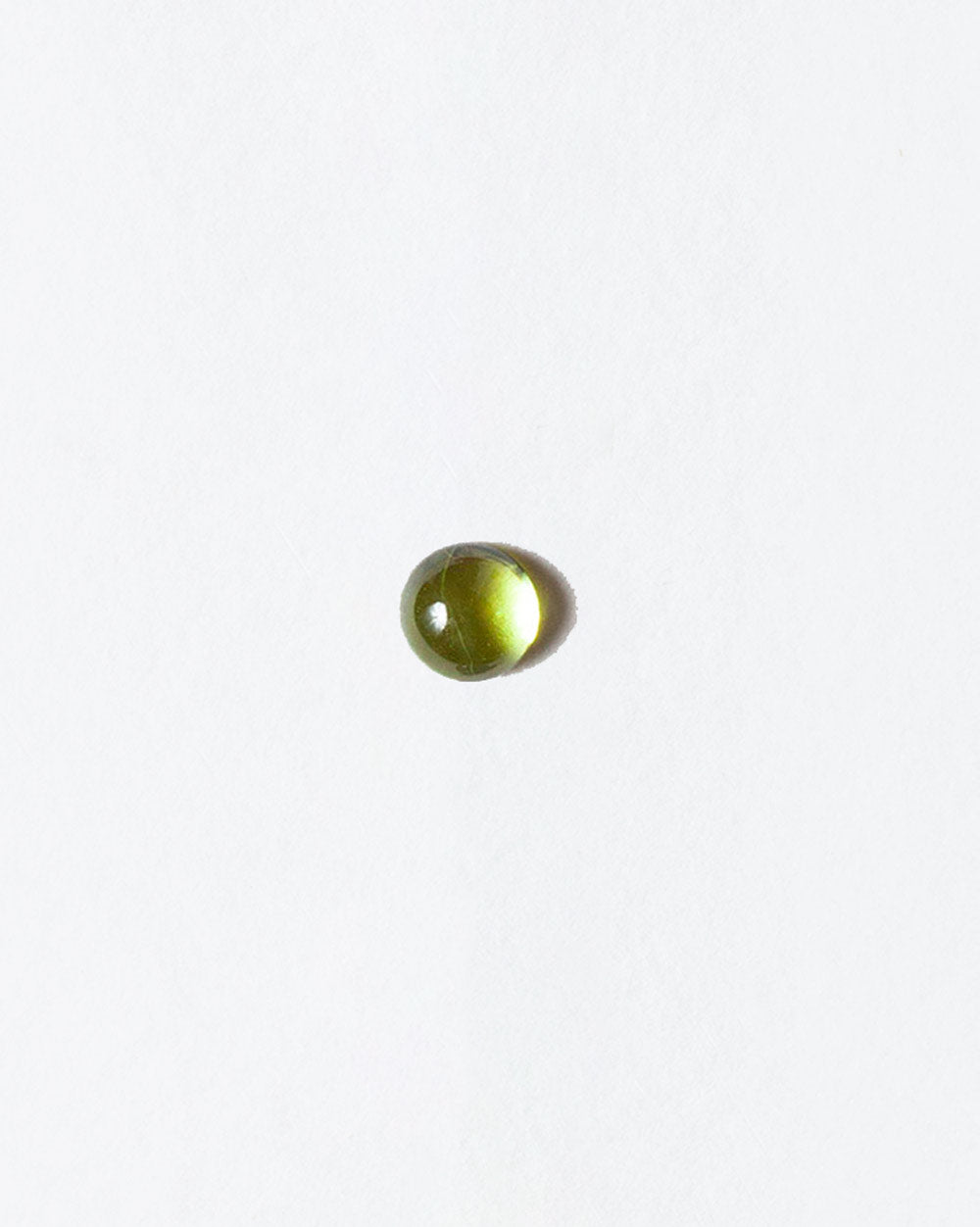 Peridot cabochon on light color background.