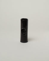 Bonam Kim Black Ear Pillar Vase on light color background.