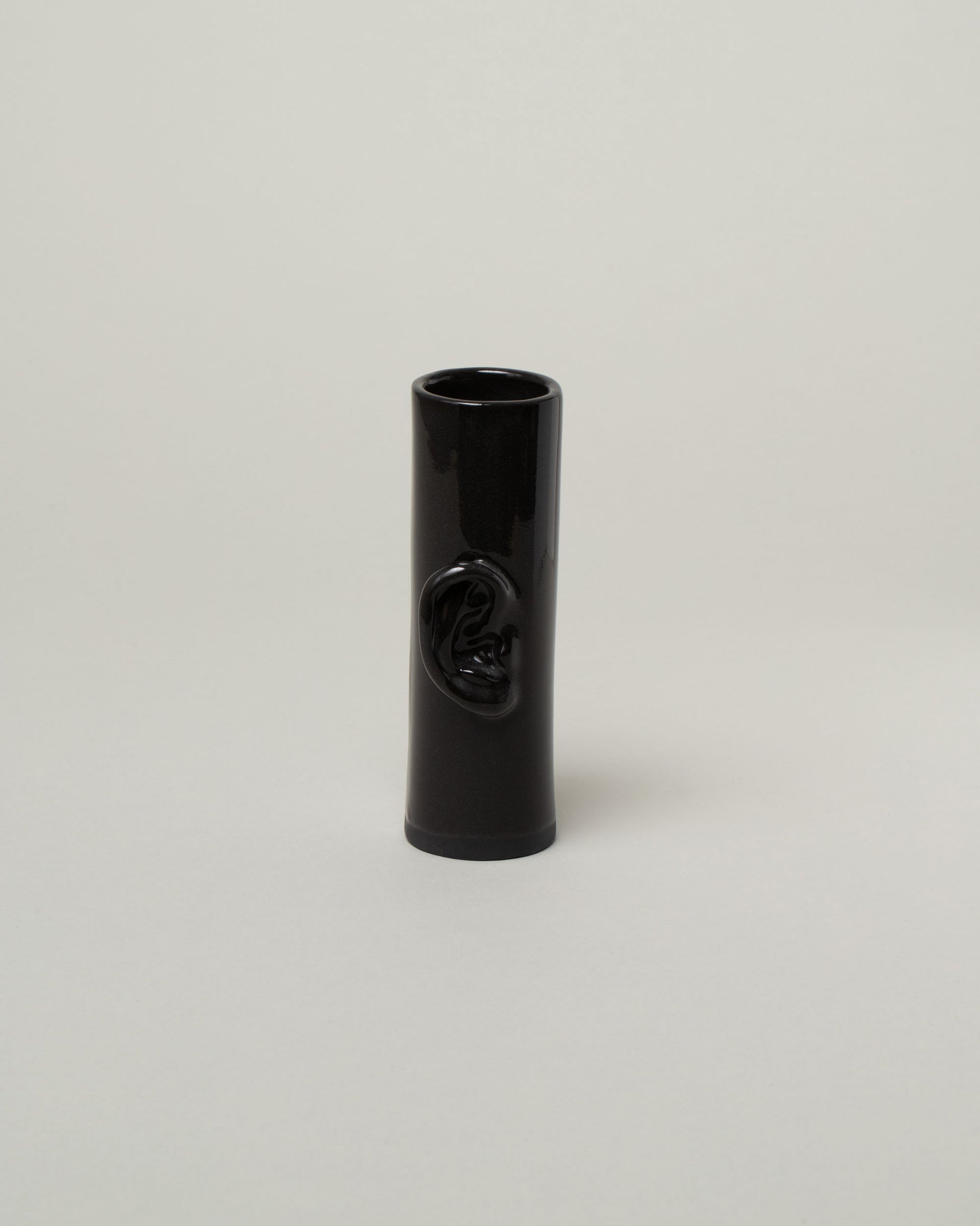 Bonam Kim Black Ear Pillar Vase on light color background.