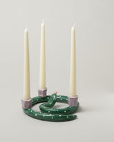 Detail view of the Laetitia Rouget Sneaky Dots Snake Candle Holder on light color background.