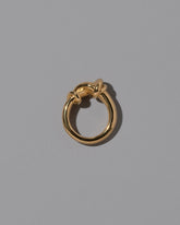 View from the side of the CRZM 22k Gold Ridge Ring on light color background.