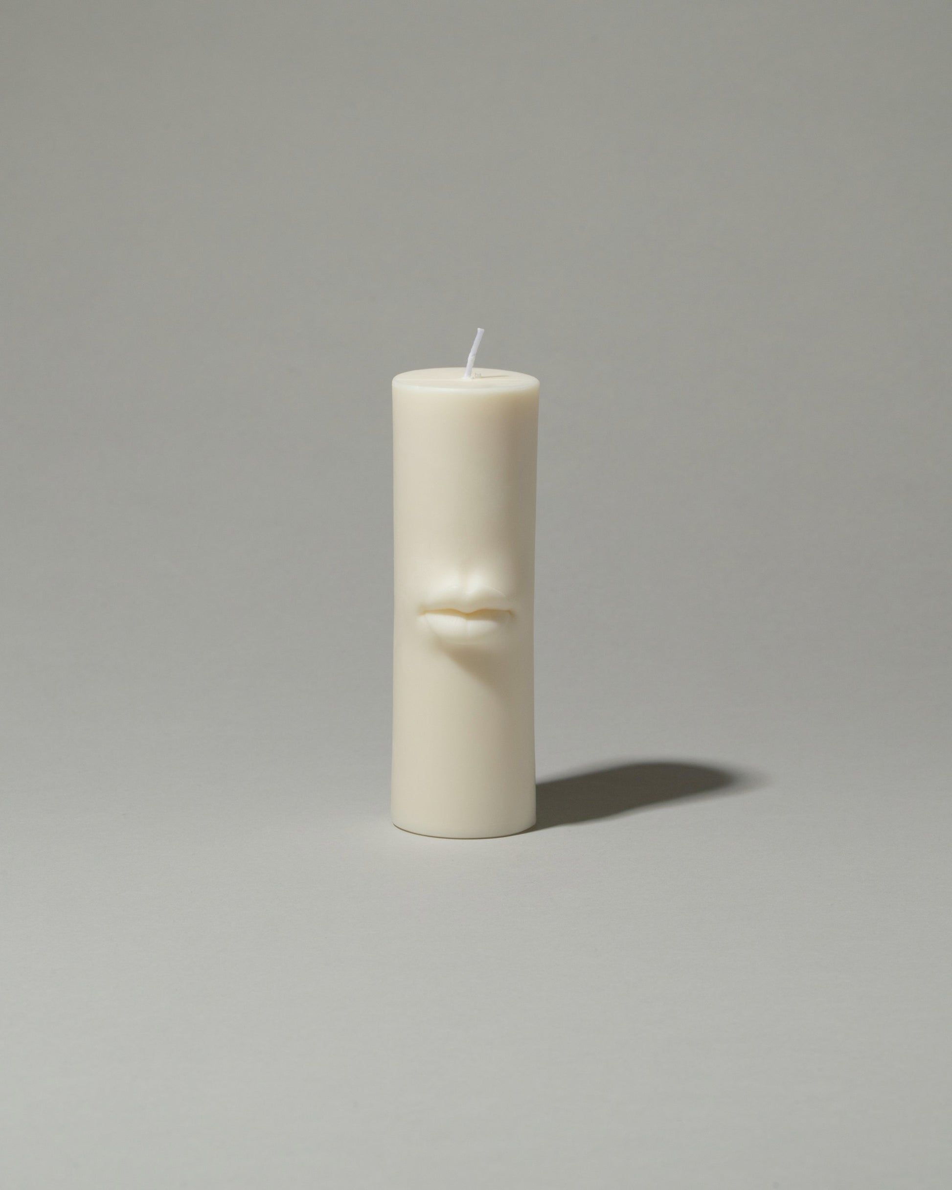 Bonam Kim Lips Pillar Candle on light color background.