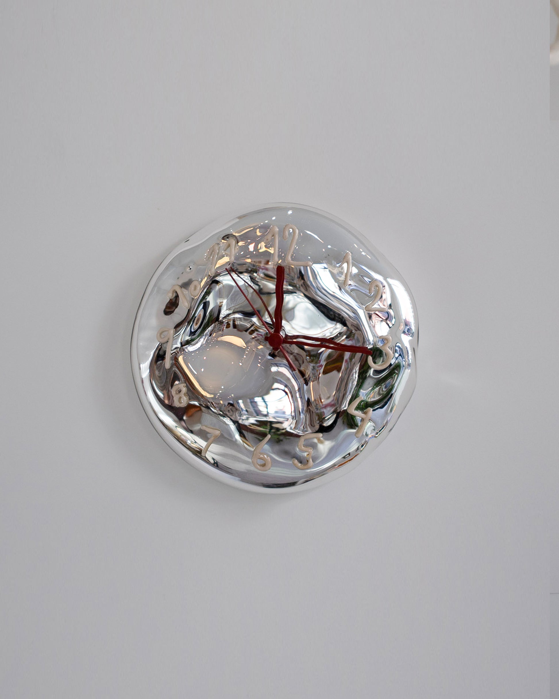 Silje Lindrup Cream Glass Wall Clock on light color background.