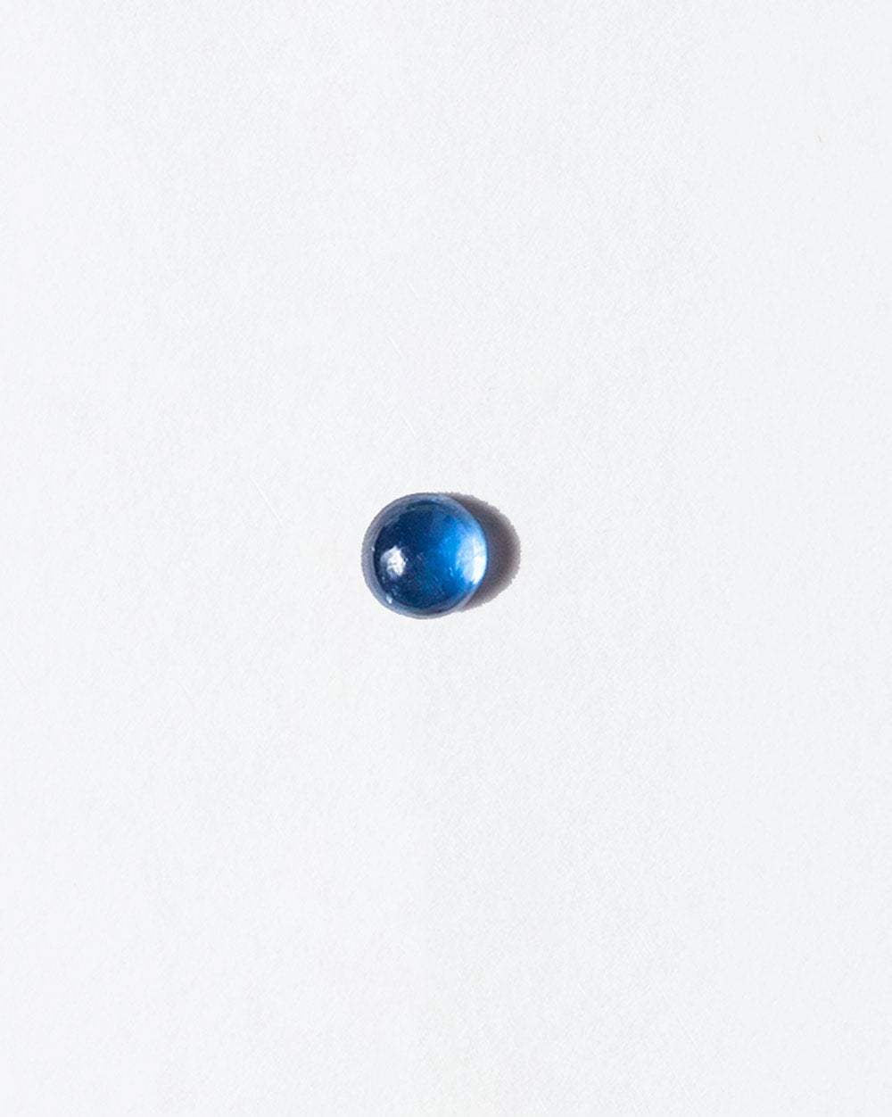 Sapphire cabochon on light color background.