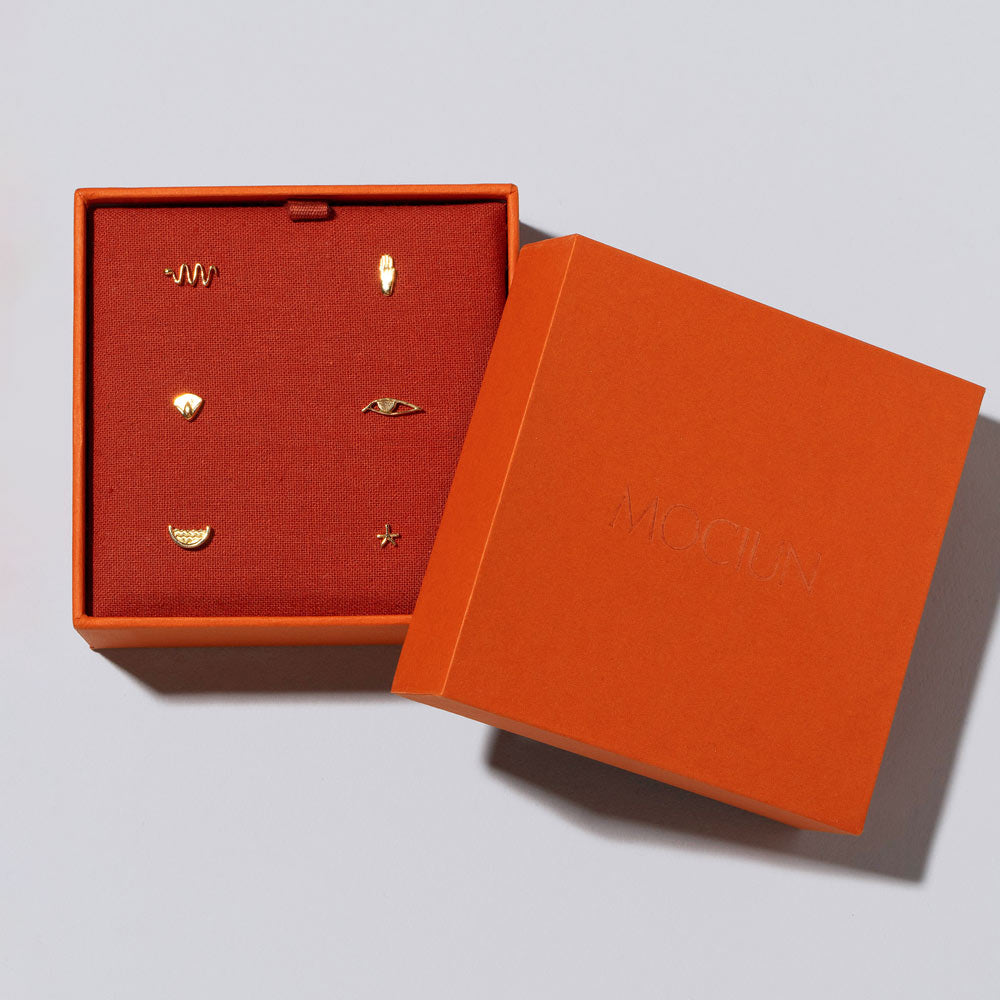 product_details::Six Talisman Stud Earring Singles Set in Mociun Box on light color background.