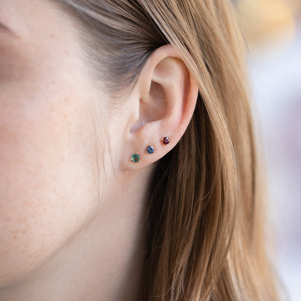 product_details::Tourmaline, Bicolor Blue Sapphire and Ruby Martini Stud Earrings on model.