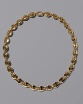 CRZM 22k Gold Bedrock Necklace on light color background.
