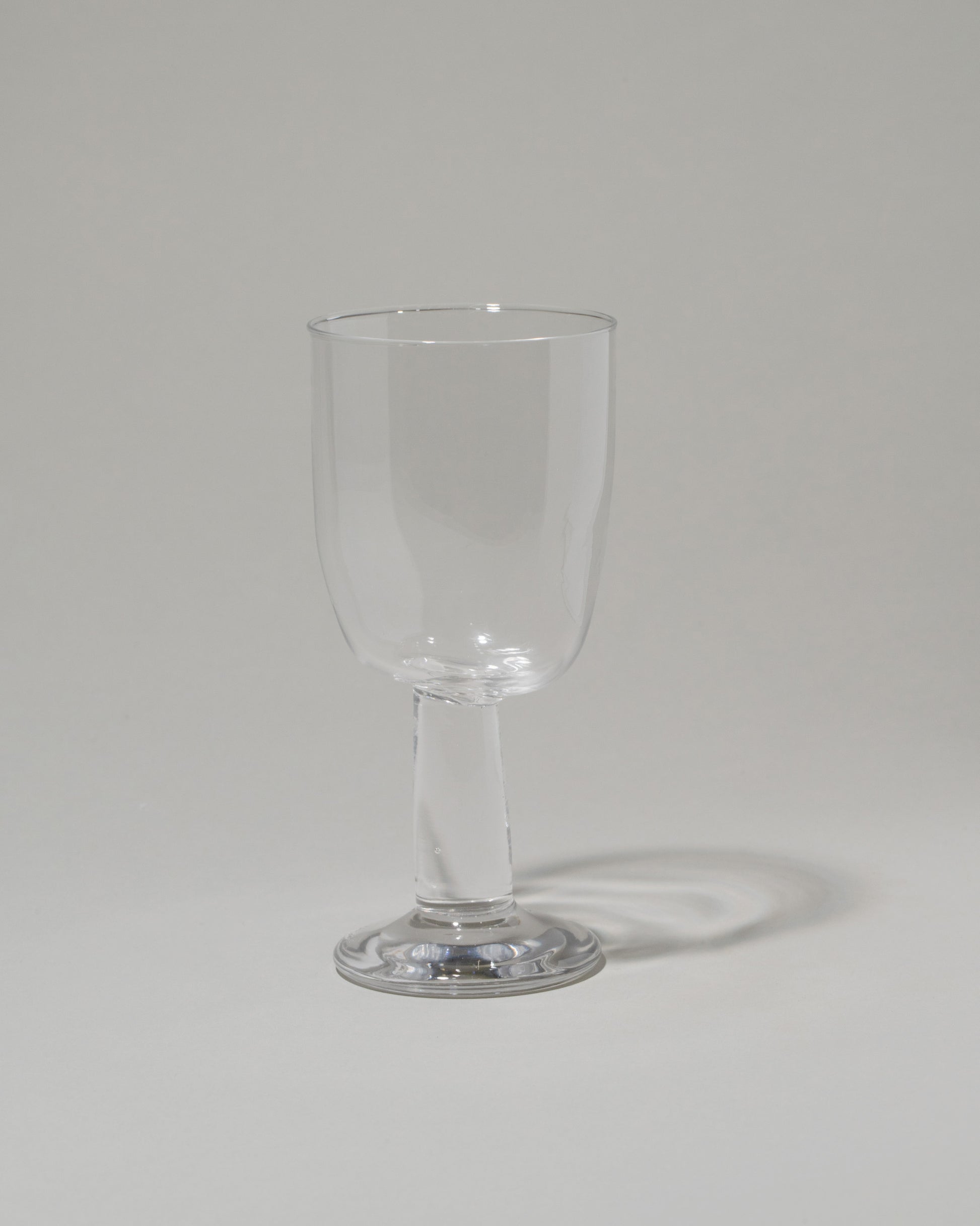 Silje Lindrup Twisted Wine Glass on light color background.