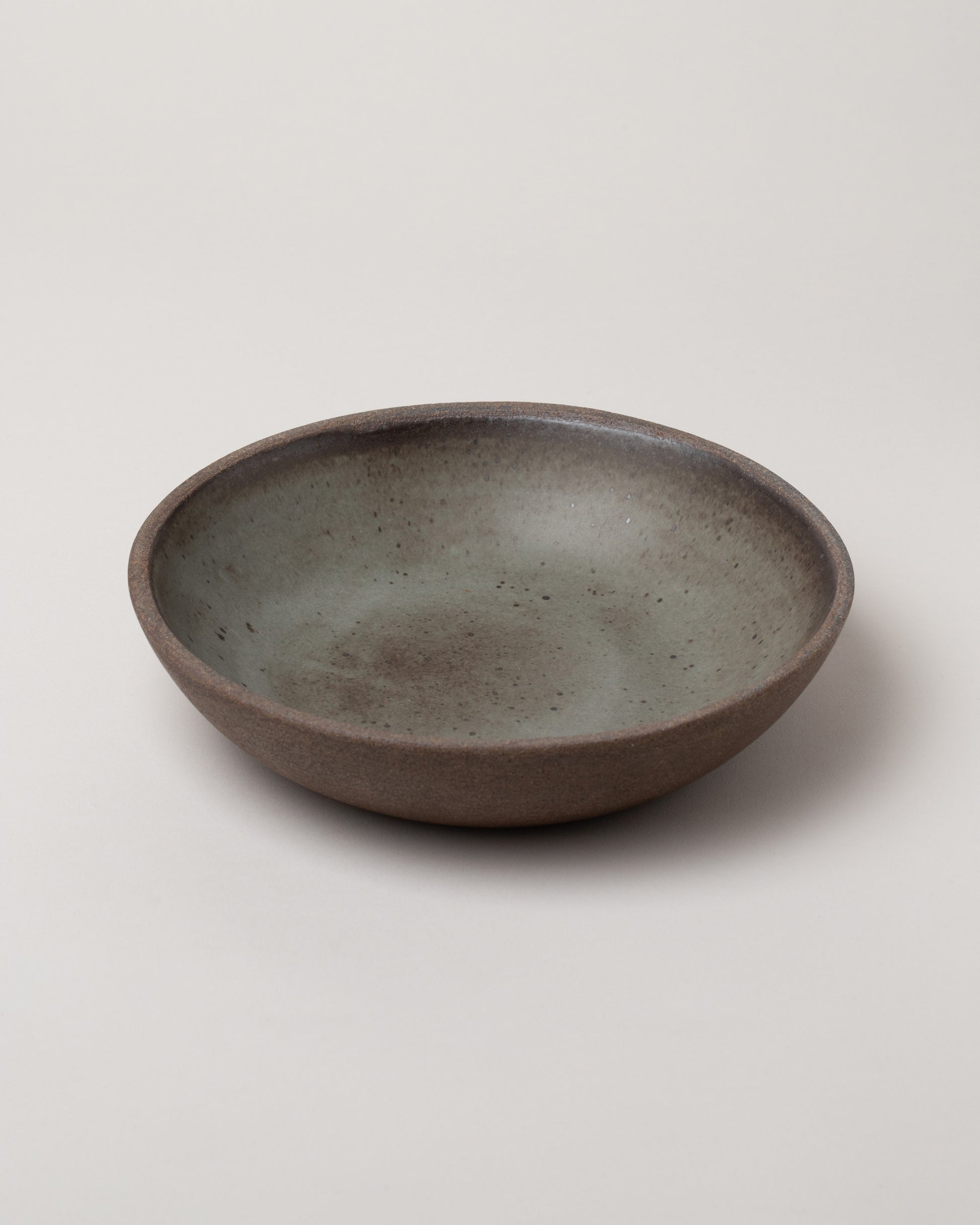 Humble Ceramics Brownstone & Danish Pine Stillness Bowl on light color background.