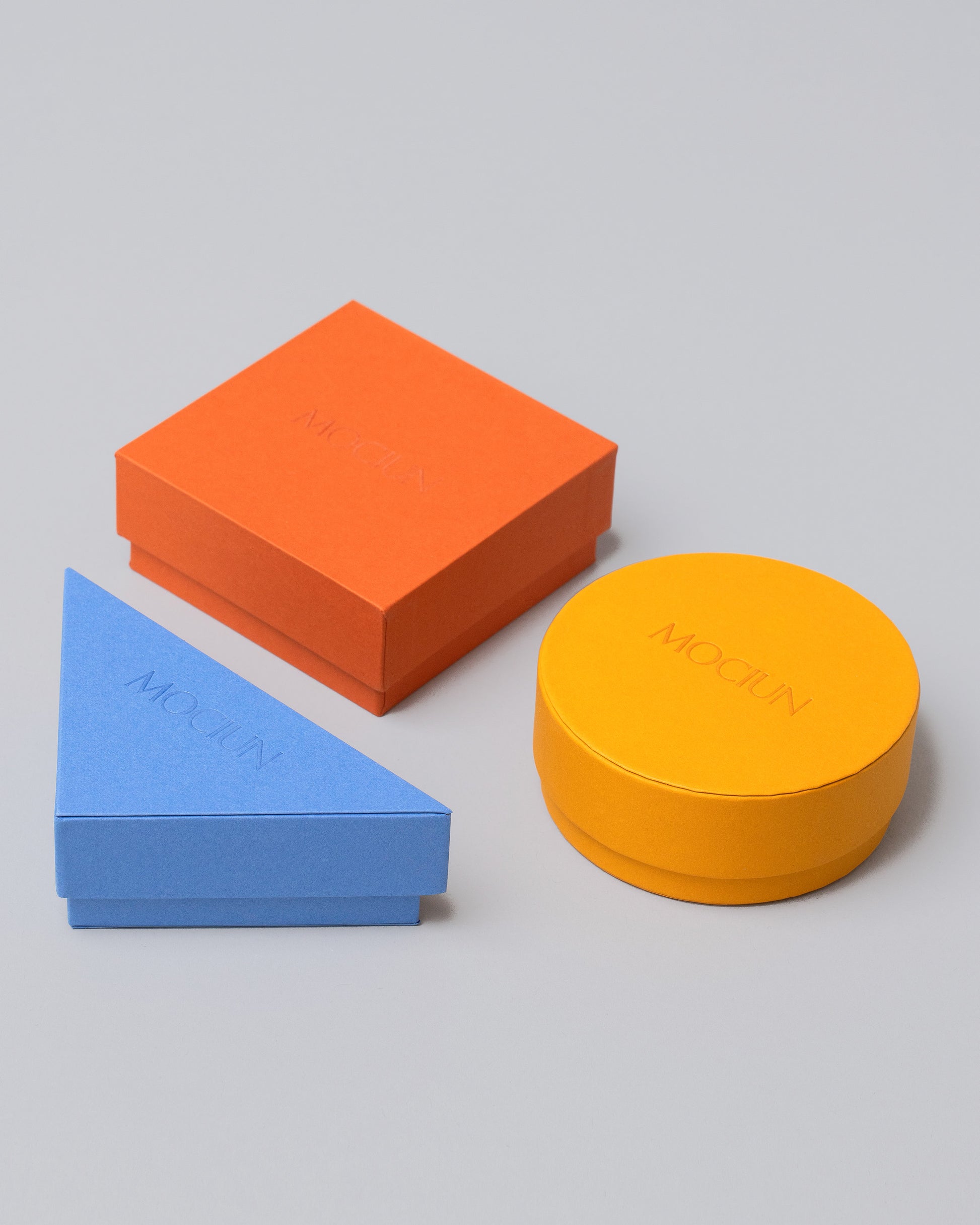 Group of Blue, Orange and Yellow Standard Boxes on light color background.