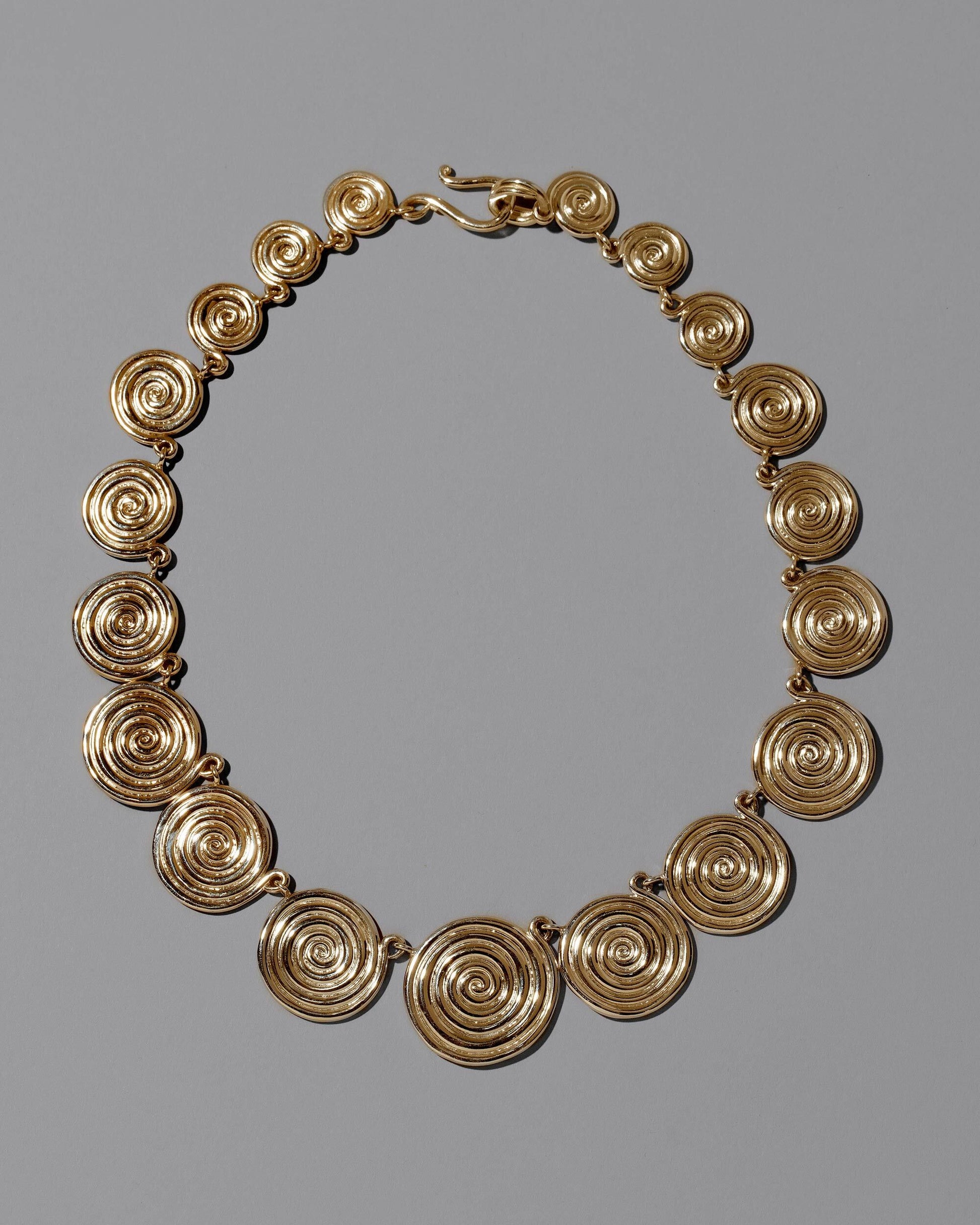 CRZM 22k Gold Serpentinite Necklace on light color background.