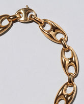 Closeup detail of the Lightweight Puff Anchor Link Bracelet on light color background.