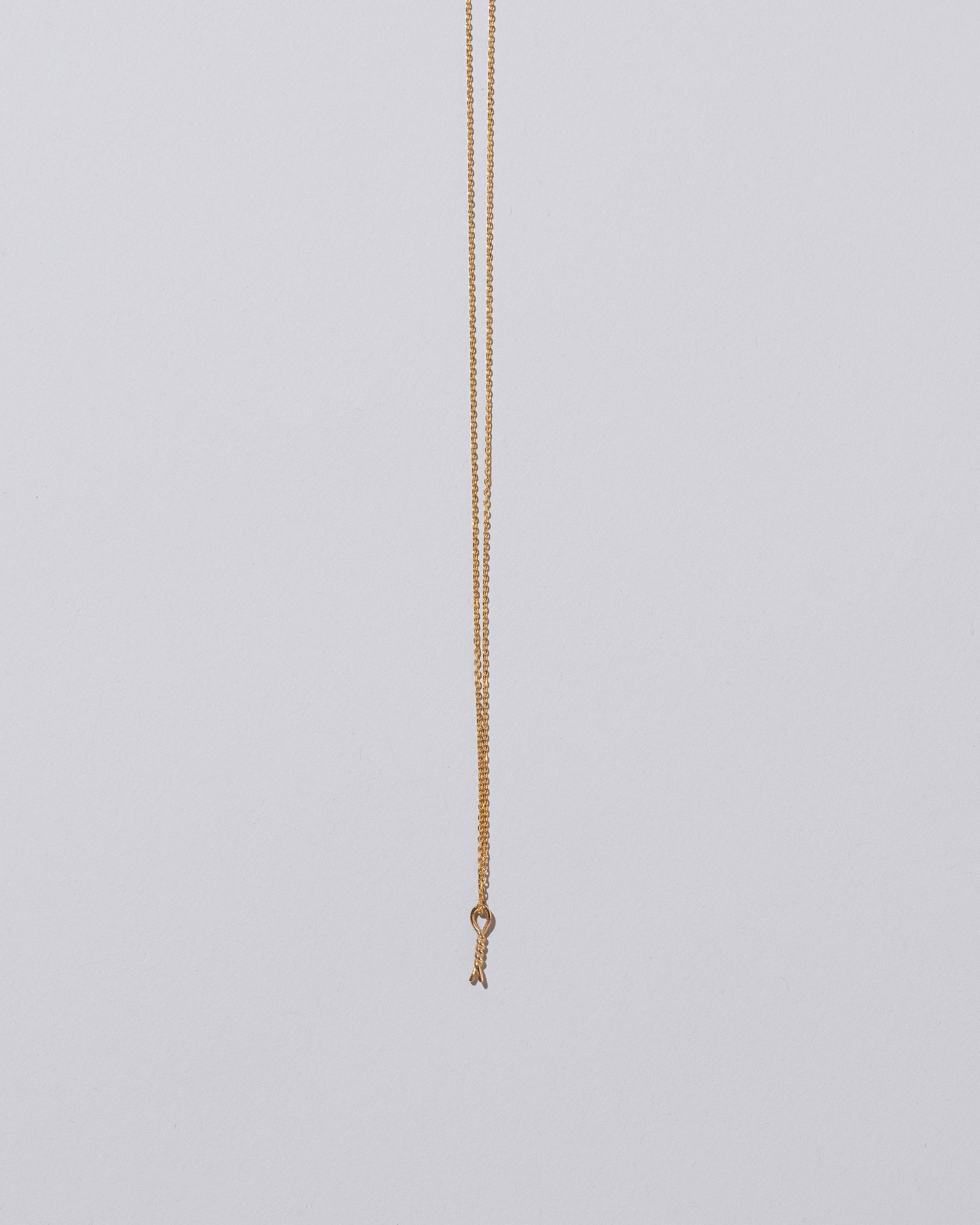 Twist Talisman Pendant Necklace on light color background.