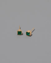 Emerald Fold Earrings on greycolor background.