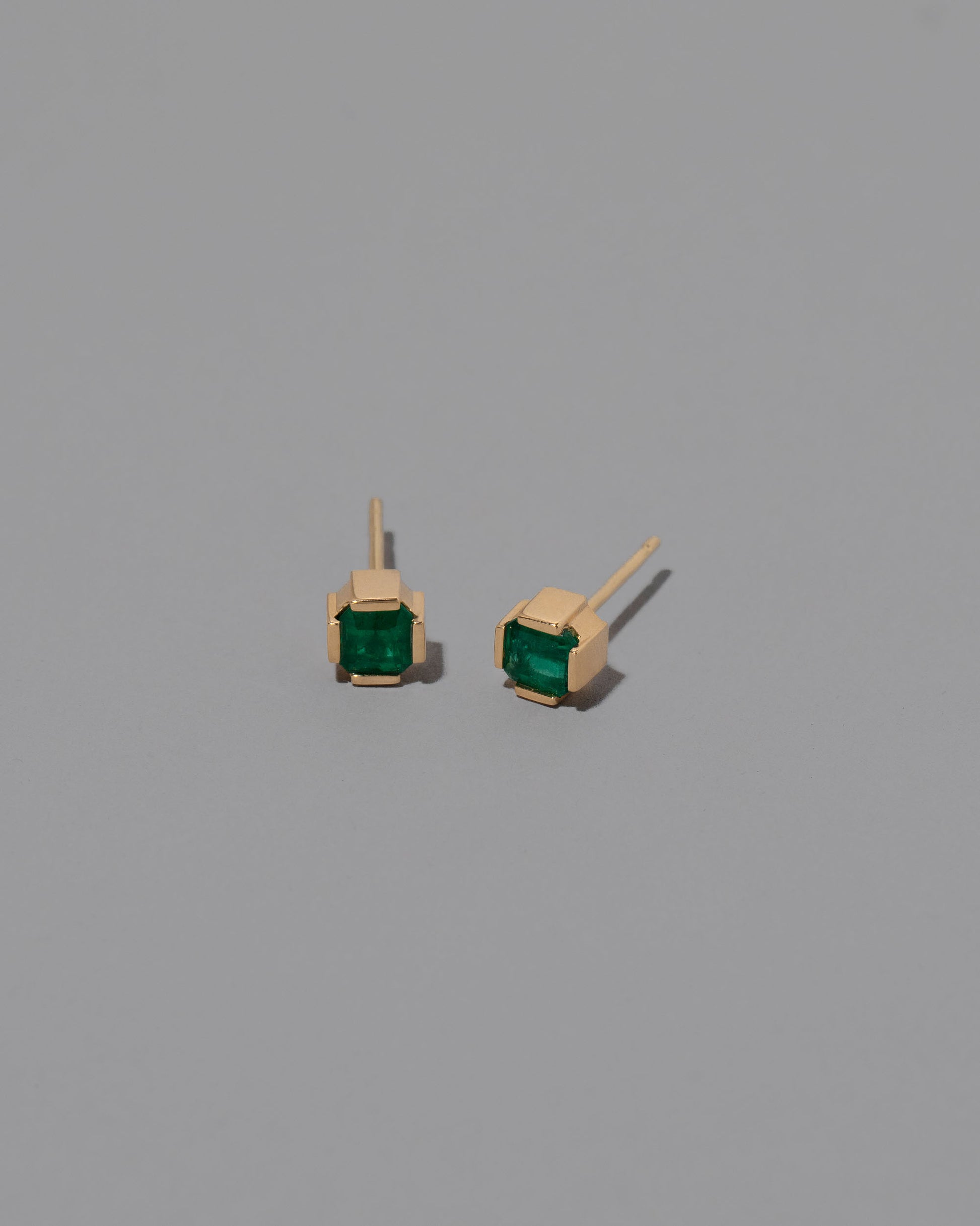 Emerald Fold Earrings on greycolor background.