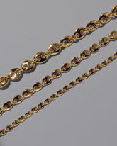 Closeup details of the CRZM 22k Gold Bedrock Mini Bracelet, 22k Gold Bedrock Medium Bracelet, and 22k Gold Bedrock Bracelet on light color background.