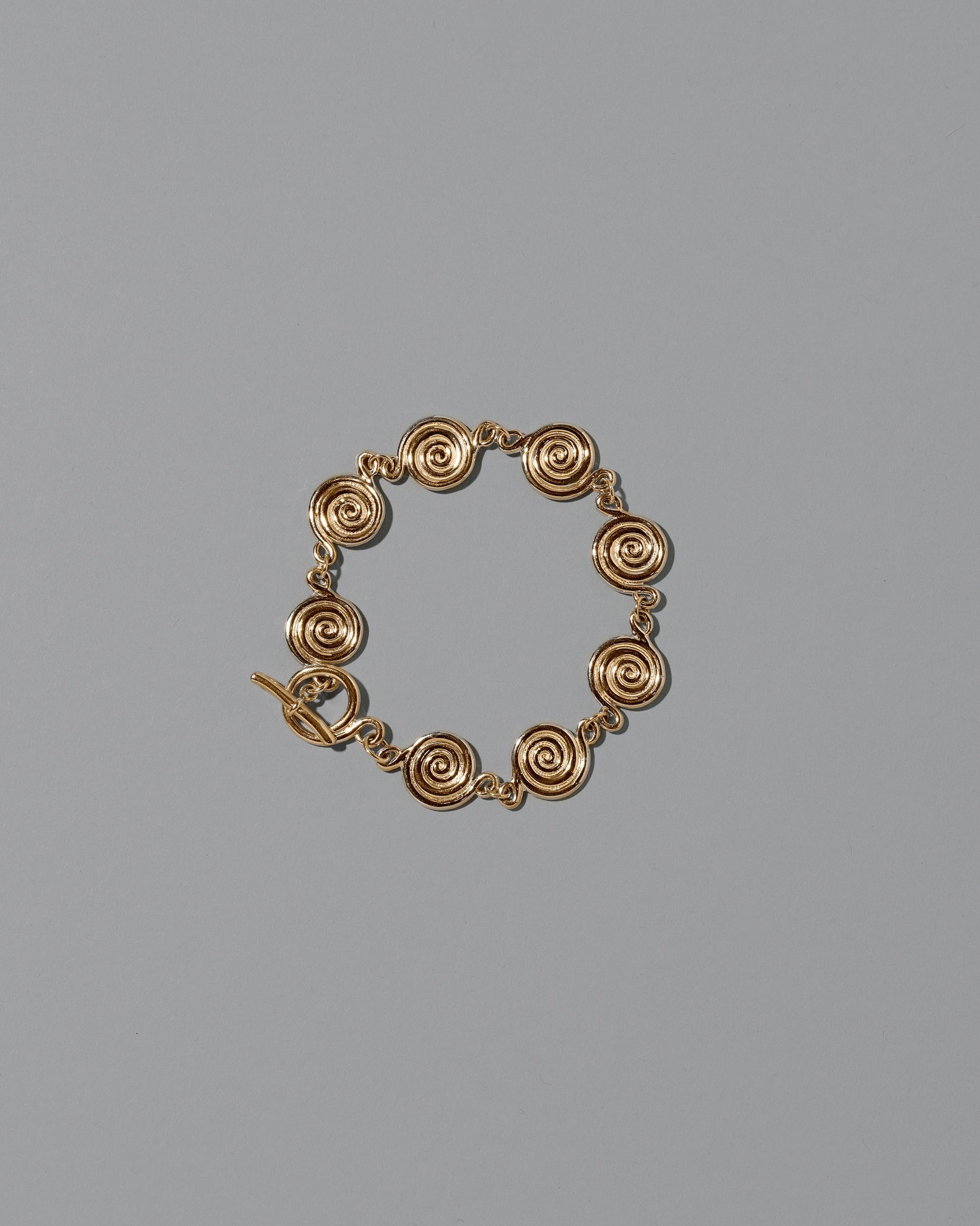 CRZM 22k Gold Serpentinite Bracelet on light color background.