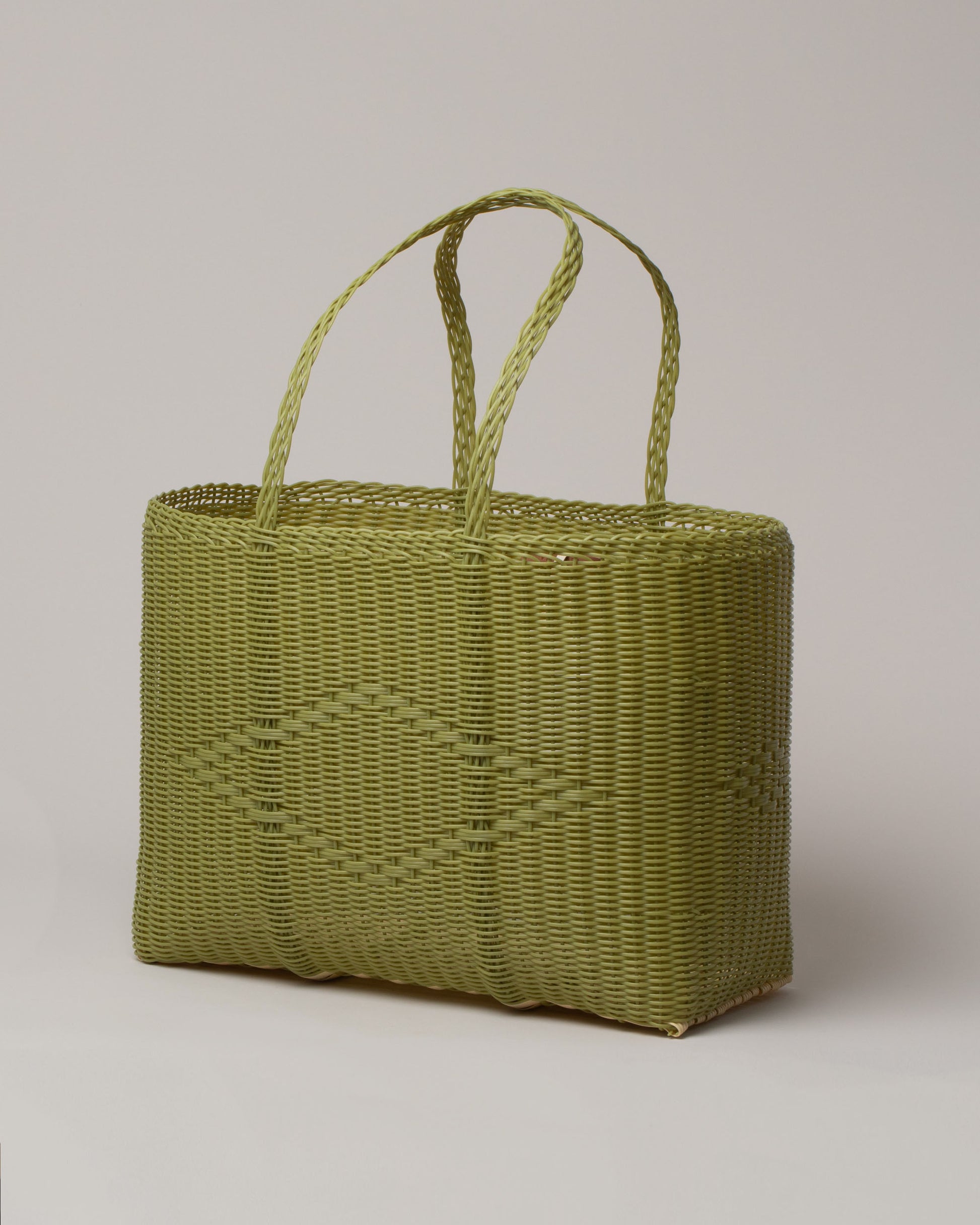 Palorosa Pistachio Large Handwoven Tote Basket Bag on light color background.