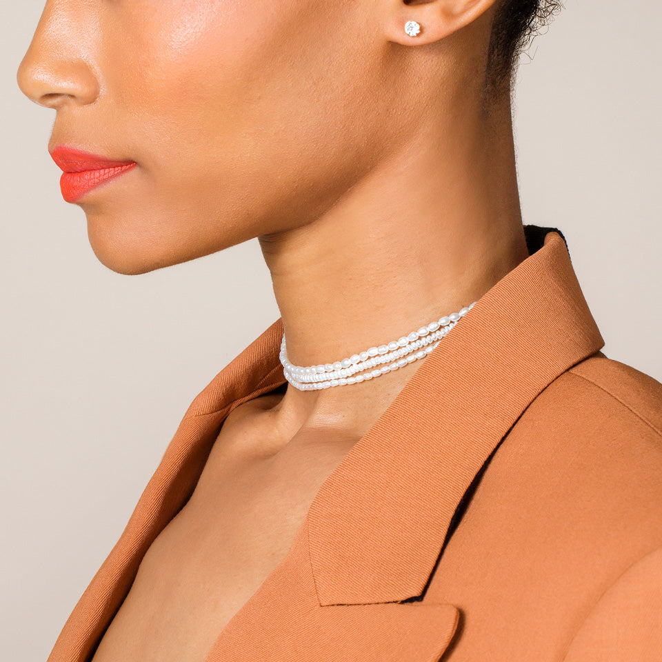 product_details::White Seed Pearl Chokers and shortened White Oval Pearl Necklaces on model.