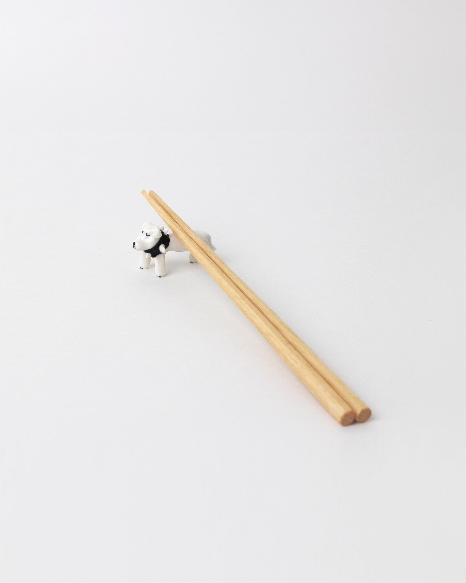 Eleonor Boström Rottweiler PARK Chopstick Dog Rest on light color background. Chopsticks not included.