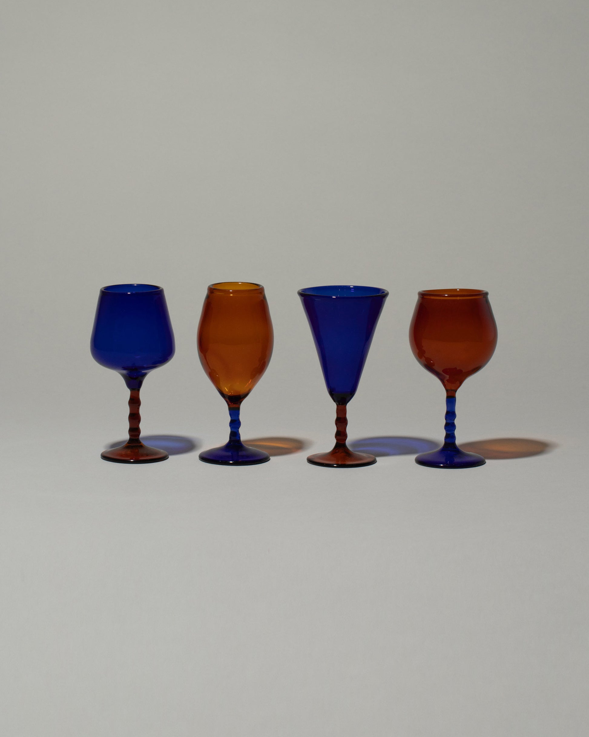 Ornamental by Lameice Amber & Royal Blue Dreamlike Liquor Glass Set on light color background.