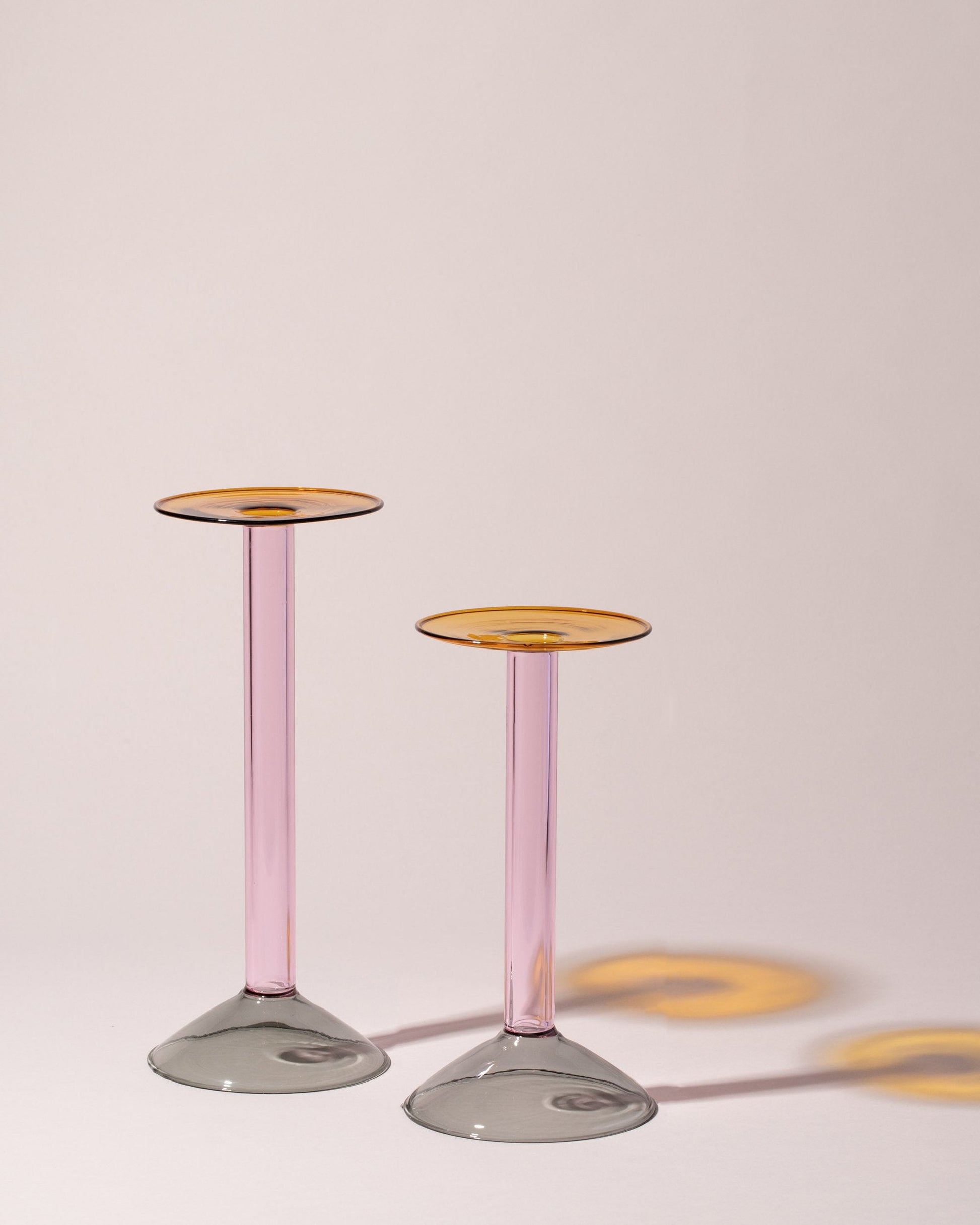 Group of Ichendorf Milano Large Grey/Pink/Amber and Medium Grey/Pink/Amber Rainbow Candleholders on light color background.