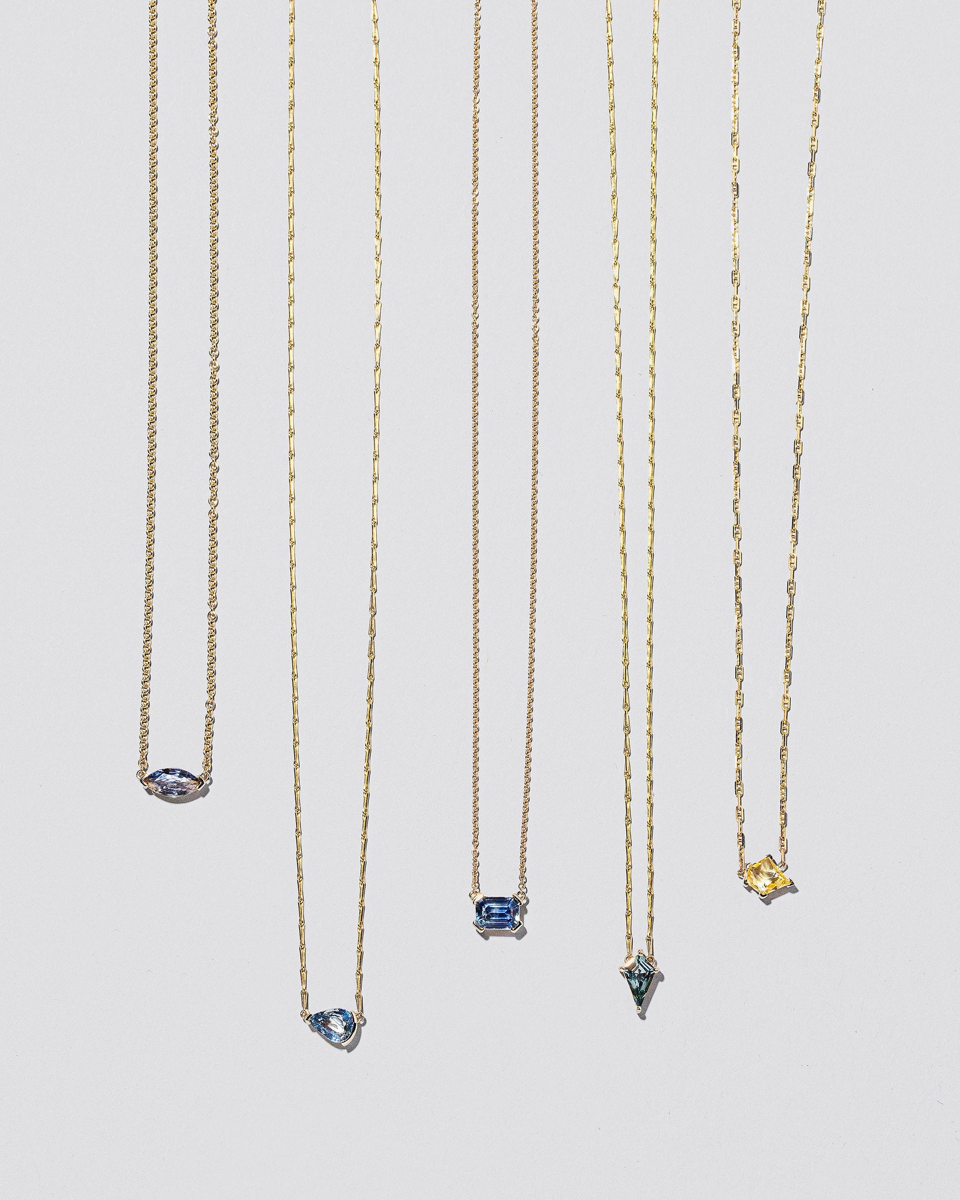 Group of Gemstone Necklaces on light colored background.