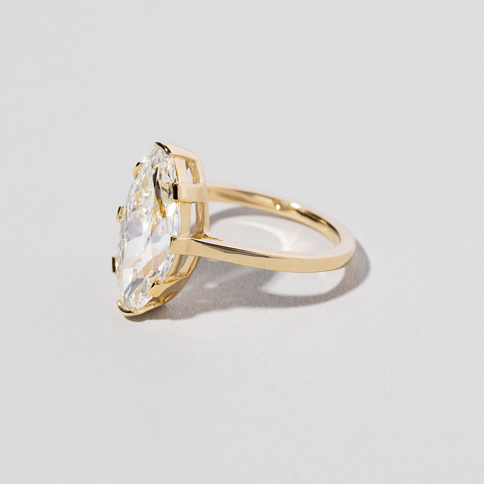 product_details:: North-South Navette Diamond Solitaire Ring on light color background.