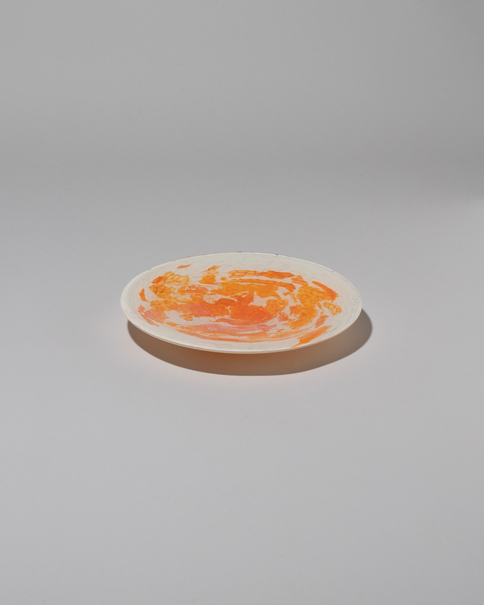 Stories of Italy Orange Nougat Dessert Plate on light color background.