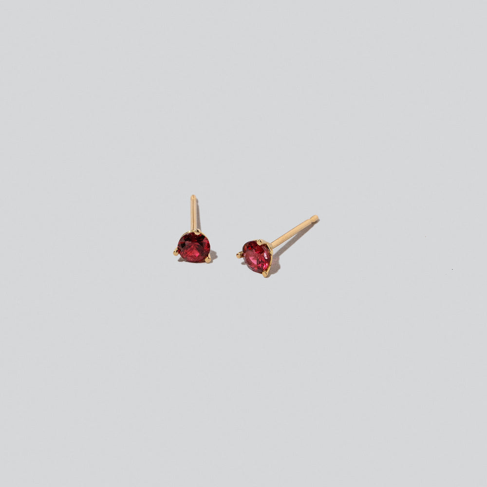 product_details::Martini Stud Earrings on light colored background.