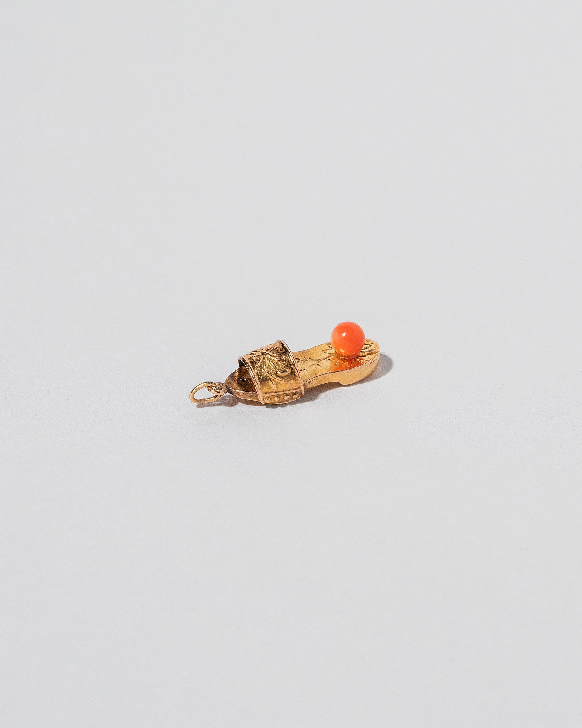  Coral Slipper Charm on light color background.