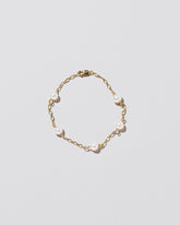 Five Pearl Station Bracelet Open Oval Chain on light color background.