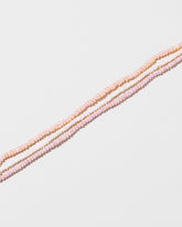  Multi Strand Seed Pearl Choker on light color background.